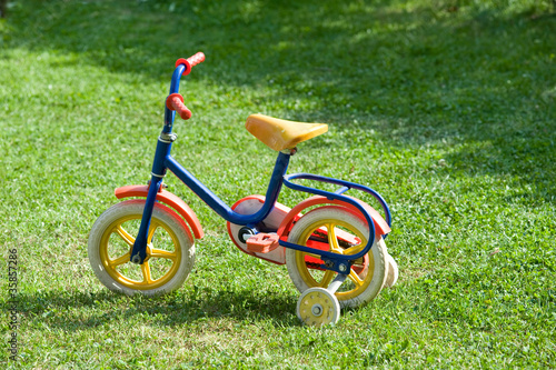 A bike for children in a garden.