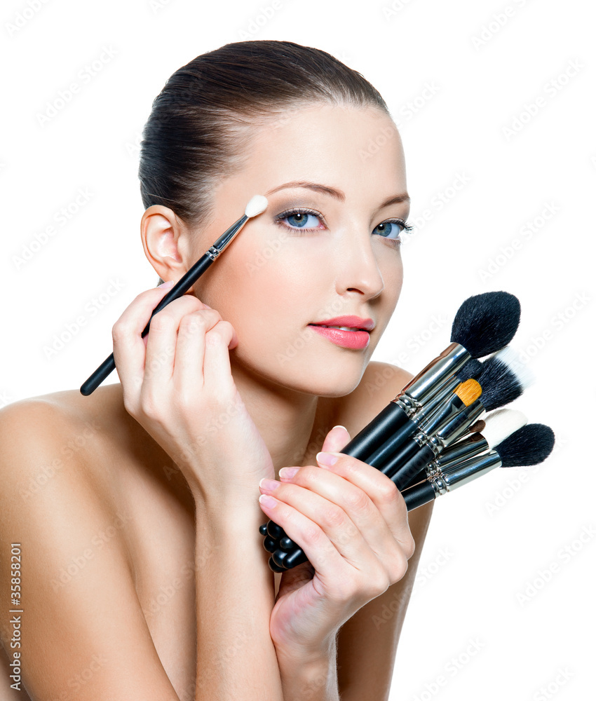 Pretty woman making make-up around the eyes. Pretty woman making make-up around the eyes.