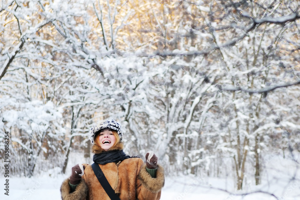 Fototapeta premium Young playful woman having fun in winter