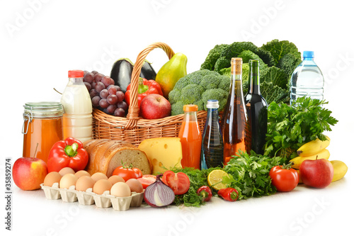 Groceries in wicker basket including vegetables and fruits