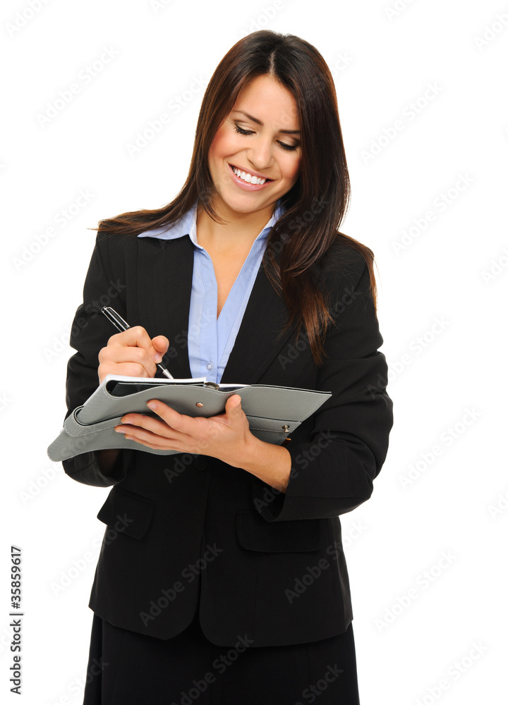 Businesswoman writing into planner Businesswoman writing into planner