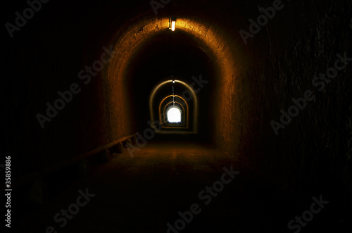 tunnel illuminated with light at the end
