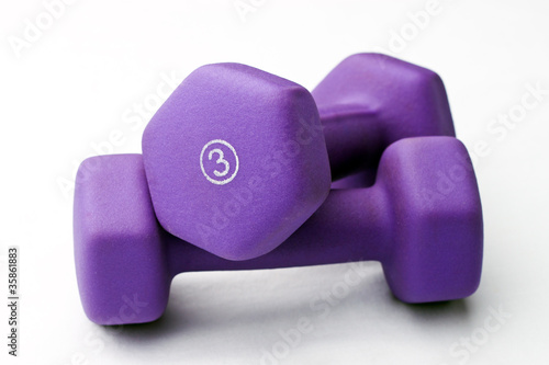 A pair of 3 lb purple neoprene weights stacked