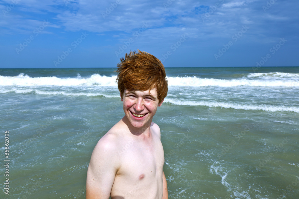 boy enjoys the waves of the sea