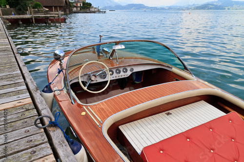 Classical wooden motor boat on alpine lake
