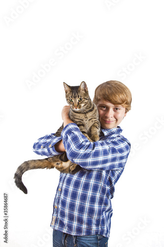 The boy holds on hands of a gray cat photo