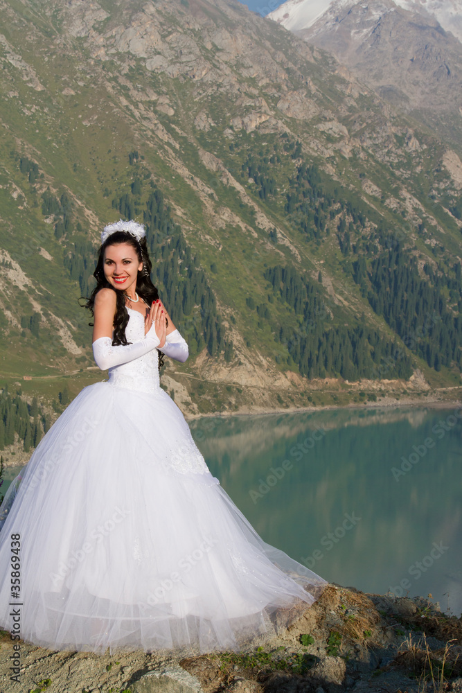 Pretty lady in a wedding dress in mountain