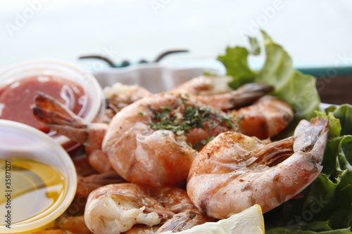 Grilled shrimps in harbour restaurant photo