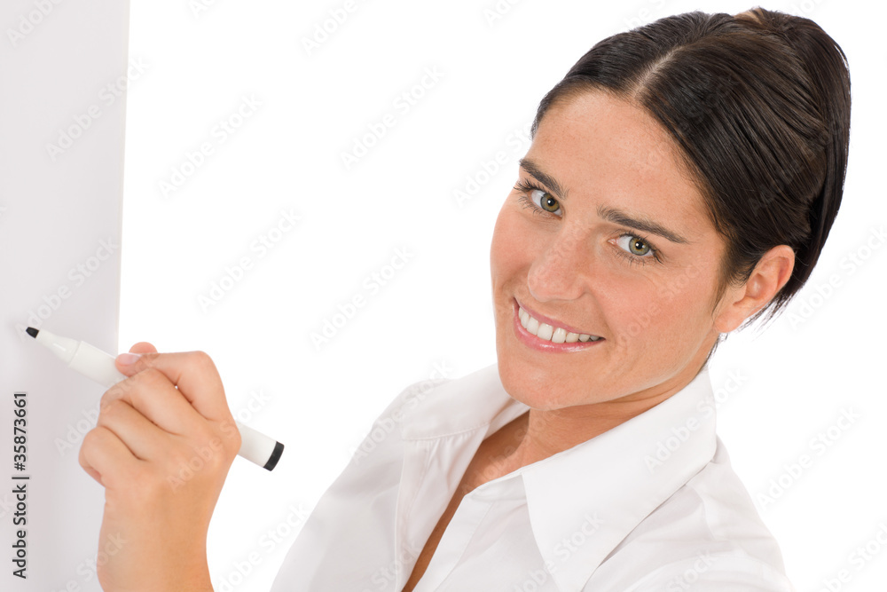Happy businesswoman writing at empty flip chart Happy businesswoman writing at empty flip chart
