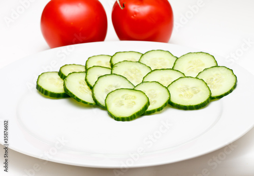 Sliced Cucumbers on White Plate with Tomatoes