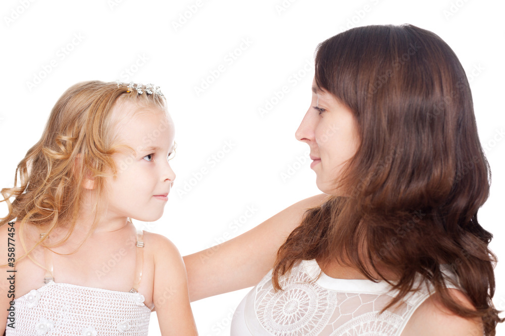 mother and daughter looking each other in eyes isolated on white mother and daughter looking each other in eyes isolated on white