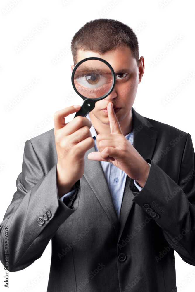 businessman in a suit looking through a magnifying glass businessman in a suit looking through a magnifying glass