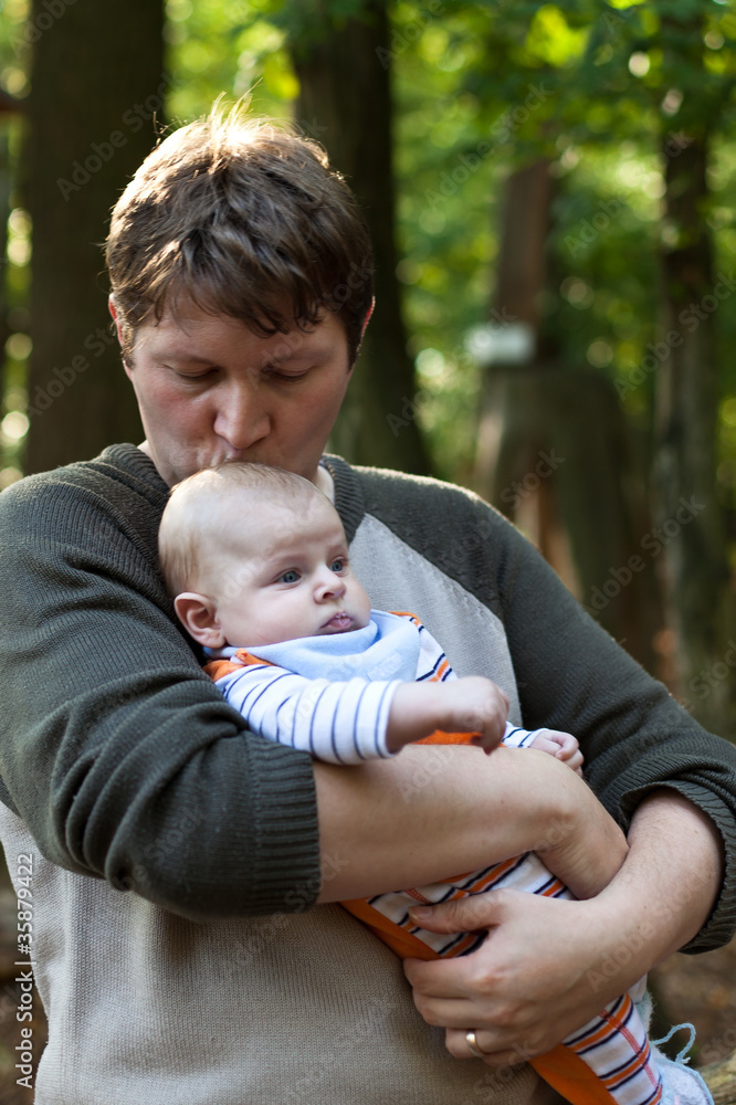 Young happy man with an adorable newborn baby boy Young happy man with an adorable newborn baby boy