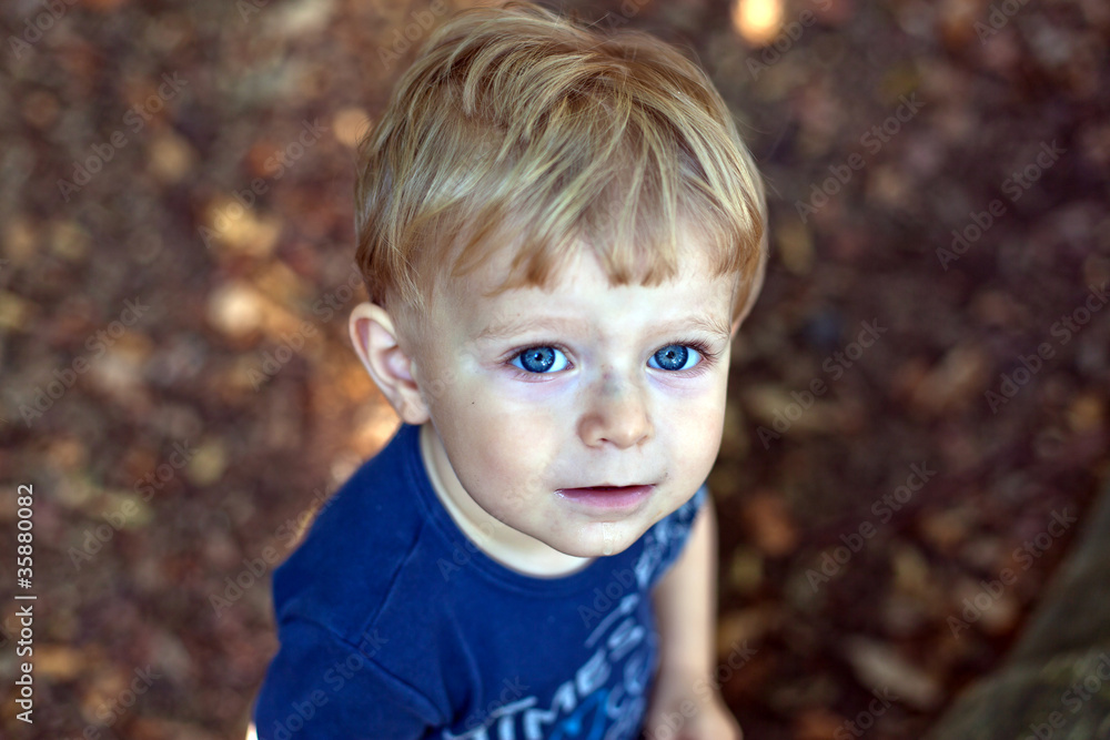 adorable baby boy with blond hairs and blue eyes