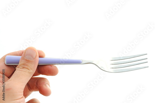 man hand holds a violet fork on white background