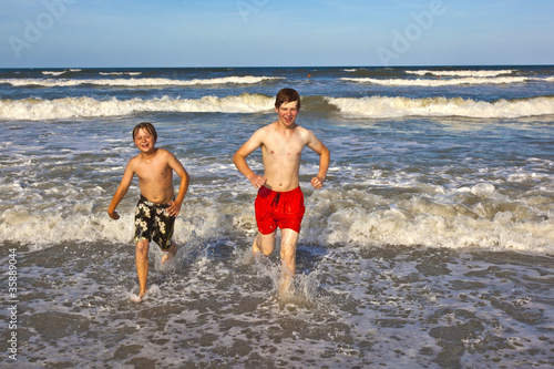 boys having fun in the beautiful clear sea © travelview