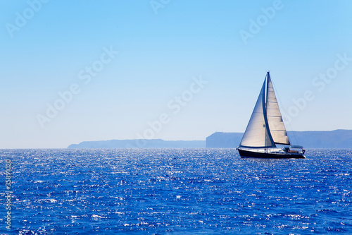 Blue Mediterranean sailboat sailing