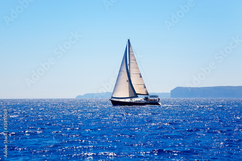 Blue Mediterranean sailboat sailing