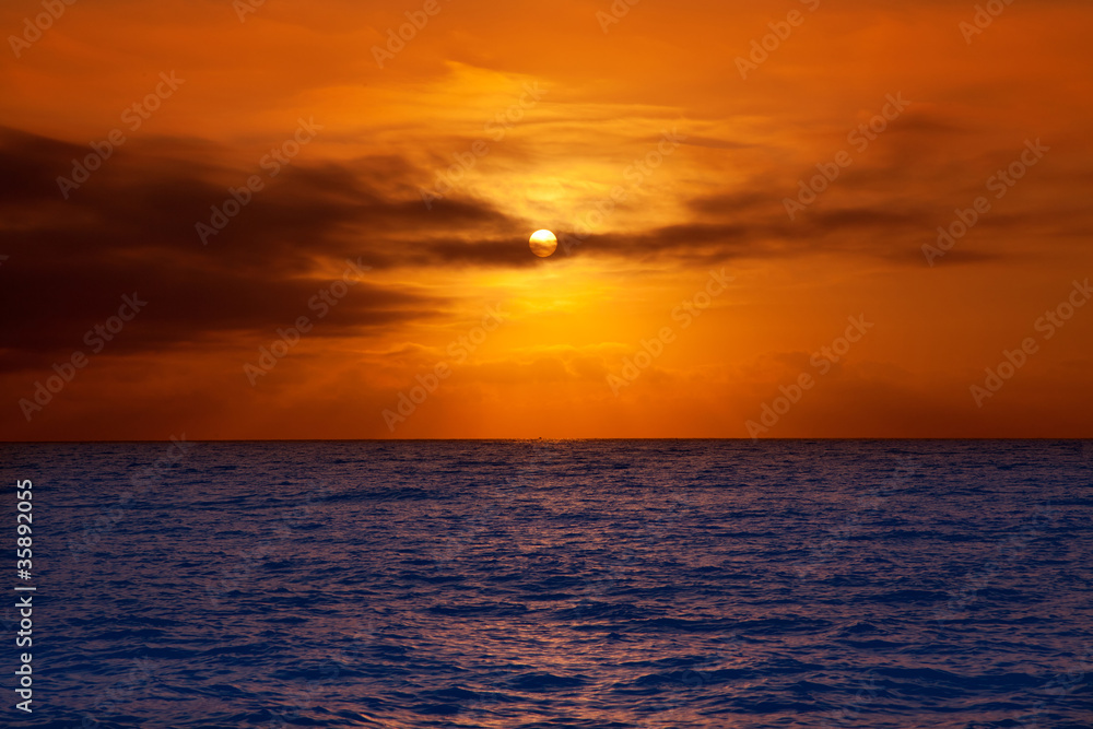 golden sunrise with sun and clouds over sea
