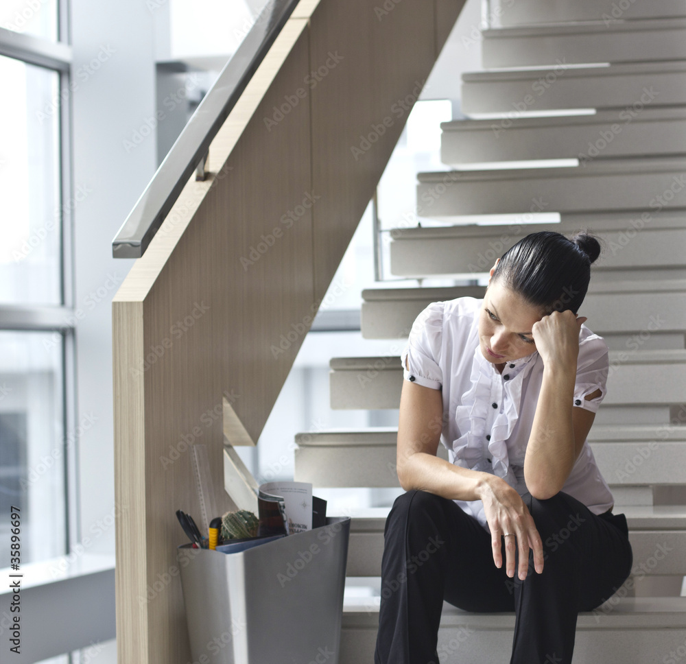 Downsizing, sad business woman Sitting on Stairs Downsizing, sad business woman Sitting on Stairs
