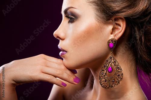elegant fashionable woman with violet jewelry