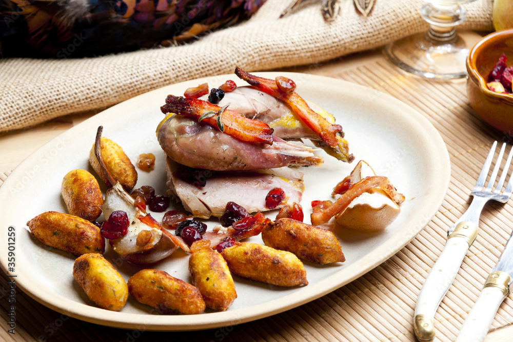 baked pheasant with bacon, pear, raisins on brandy