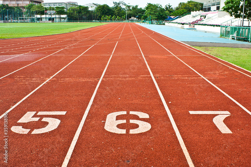 Number five six and seven on the start of a running track