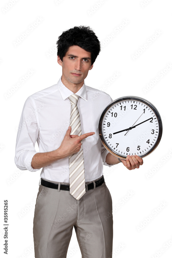 Office worker pointing his finger to a clock