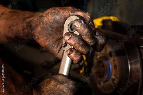 Hard working man with hands full of oil