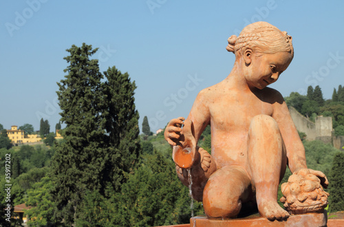 child with jug in terracotta , fountain in Florence photo