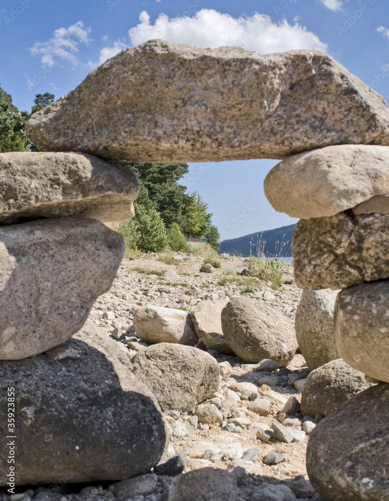 sunny illuminated pebble archway