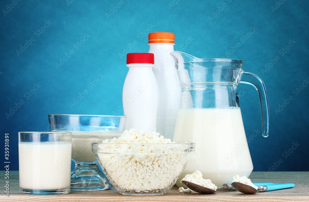 Dairy products on wooden table on blue background Dairy products on wooden table on blue background