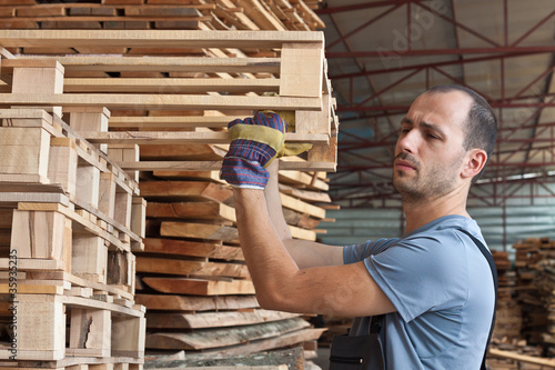 Man arranging pallets, horizontal shot