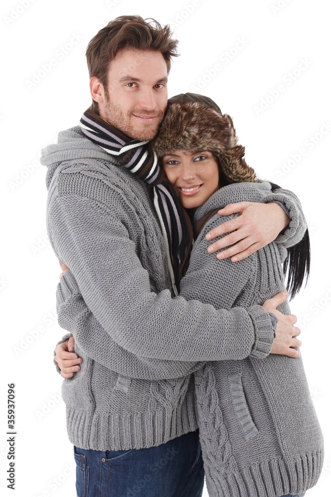 Loving couple cuddling up to each other smiling Loving couple cuddling up to each other smiling