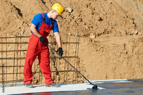 builder worker at roof insulation work