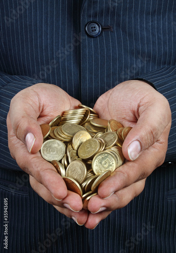 Indian Gold Coins in Hands photo