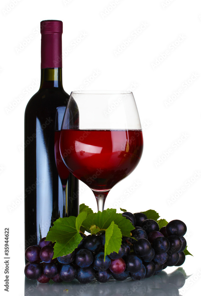 Ripe grapes, wine glass and bottle of wine isolated on white