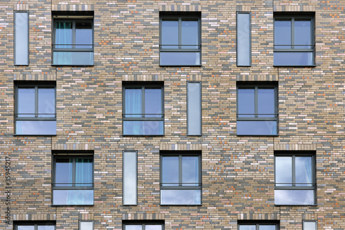 Abstract pattern of building facade with bricks and windows in B