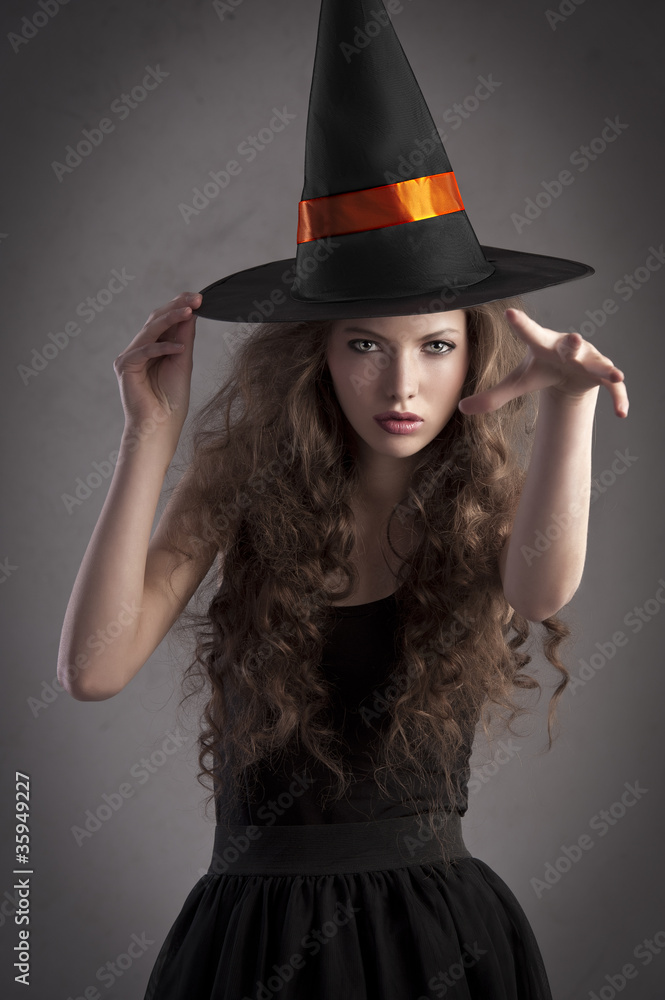 pretty girl wearing a huge witch hat pretty girl wearing a huge witch hat