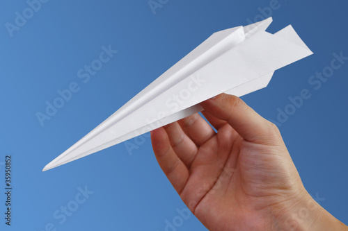 Paper aeroplane with sky background