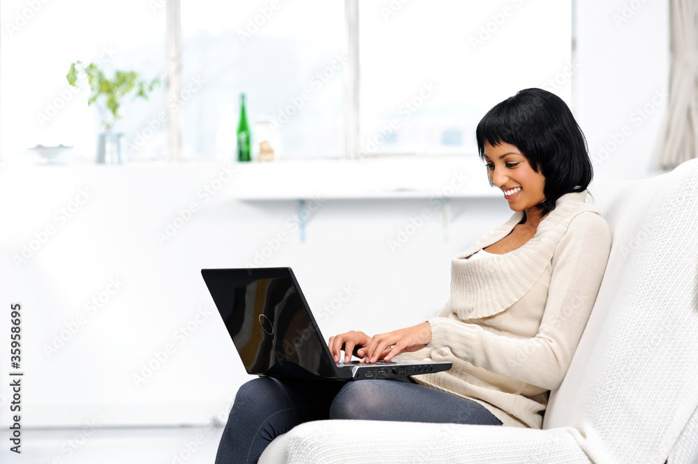 Happy woman surfing the internet from home Happy woman surfing the internet from home