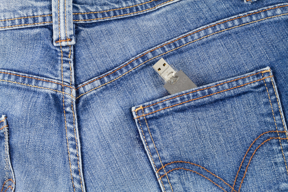 Flash USB drive memory coming out of jeans pocket Flash USB drive memory coming out of jeans pocket