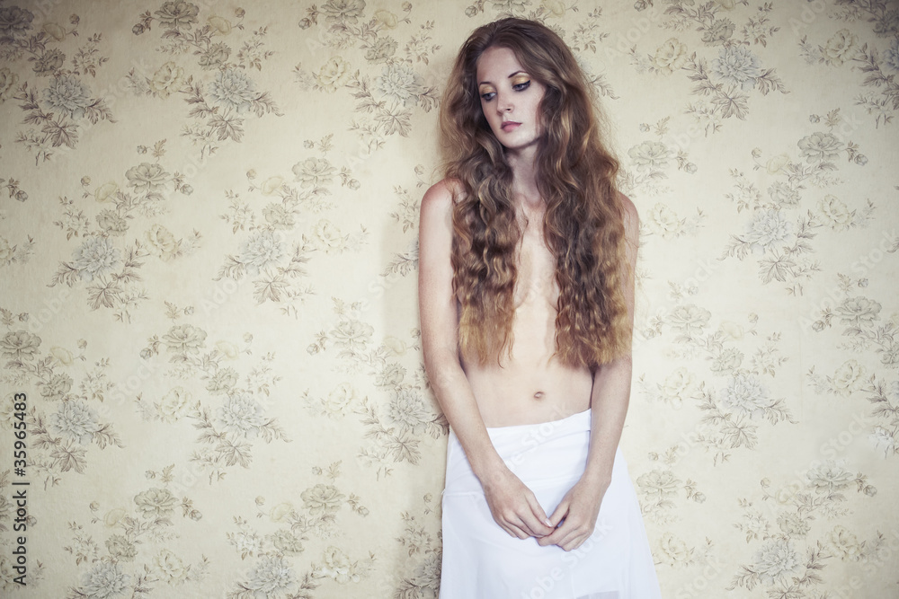 Naklejka premium Photo of young beautiful woman with red curly hair
