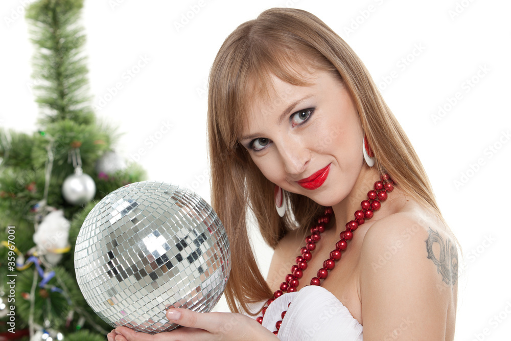 Young woman with mirrored ball near christmas tree. Young woman with mirrored ball near christmas tree.