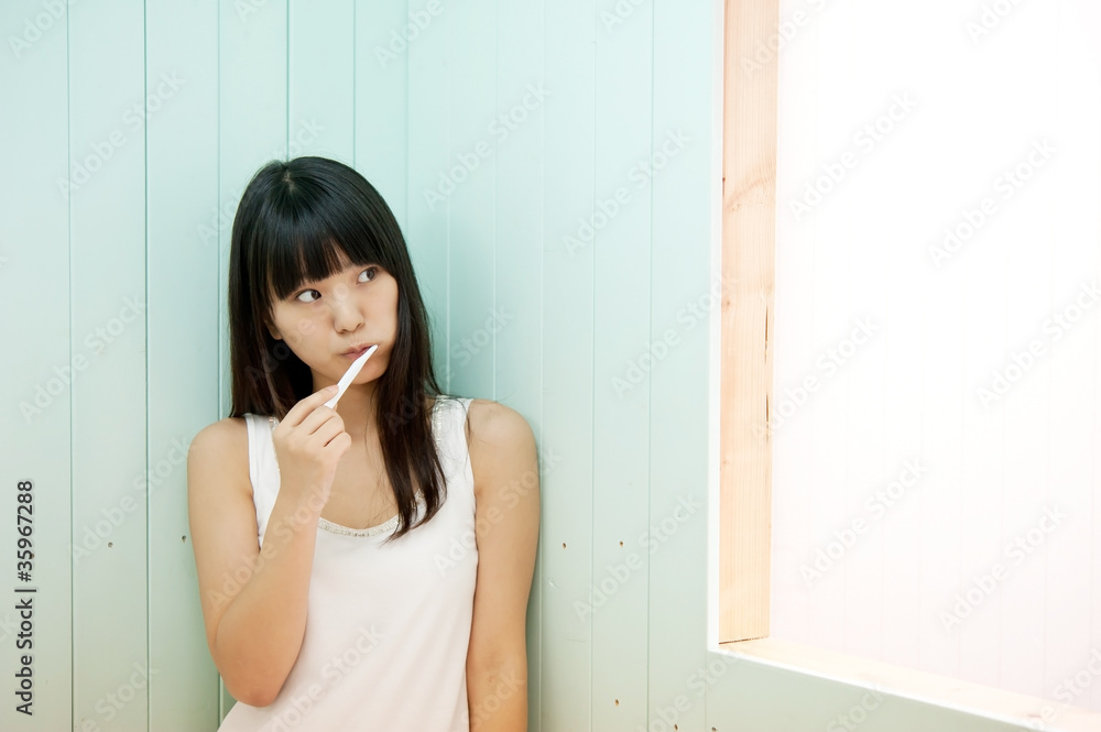 pretty asian woman brushing her teeth pretty asian woman brushing her teeth