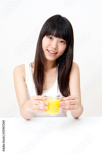 pretty asian woman drinking orange juice