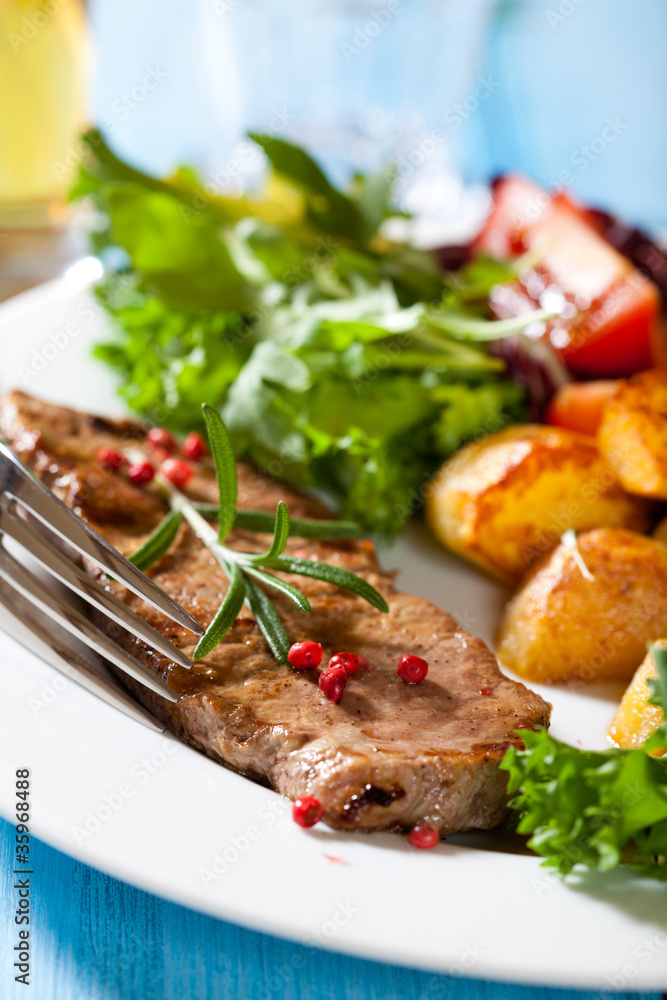 Grilled steak with baked potatoes and fresh vegetables Grilled steak with baked potatoes and fresh vegetables
