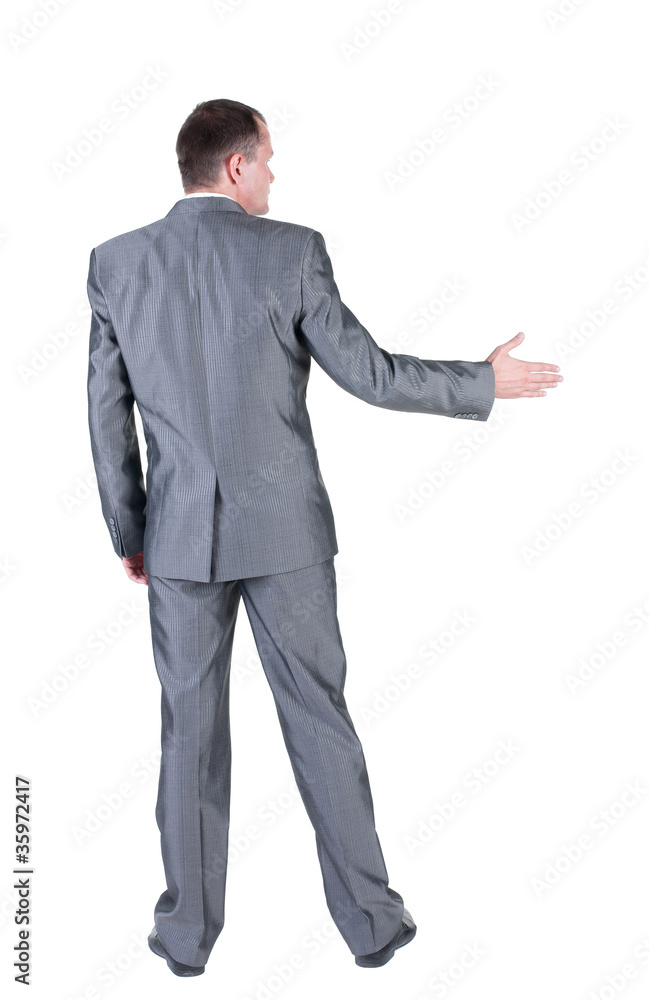 businessman extending hand to shake. Rear view. businessman extending hand to shake. Rear view.