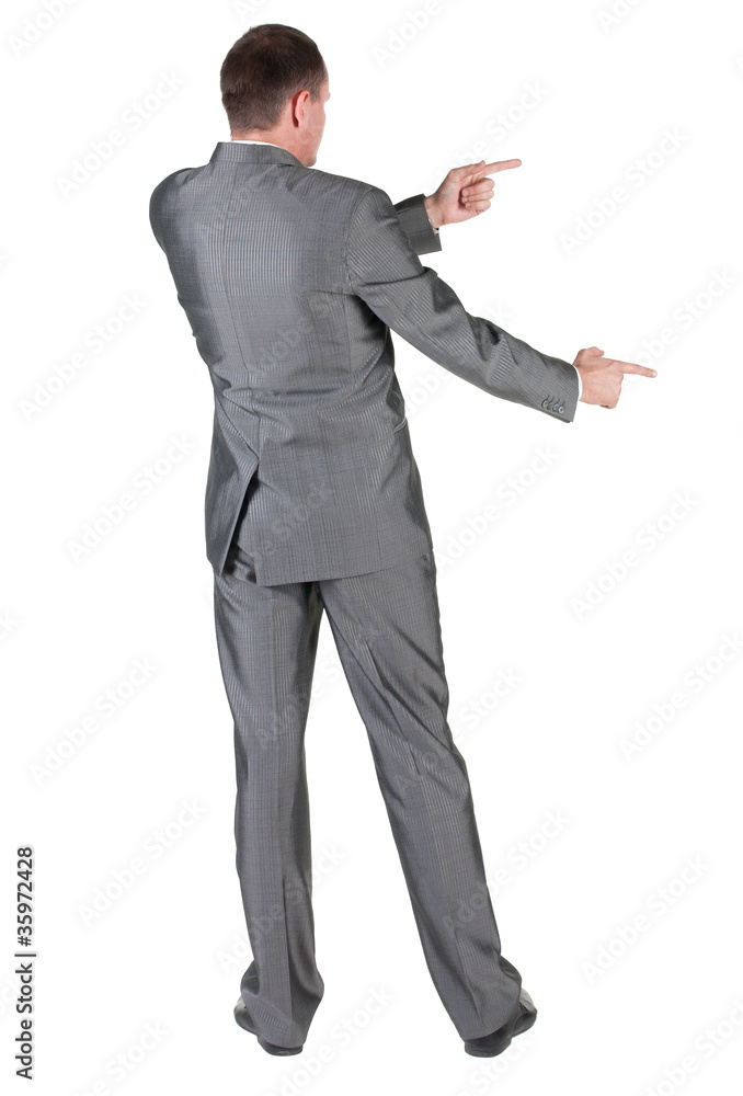 Businessman pointing at wall. rear view. Businessman pointing at wall. rear view.