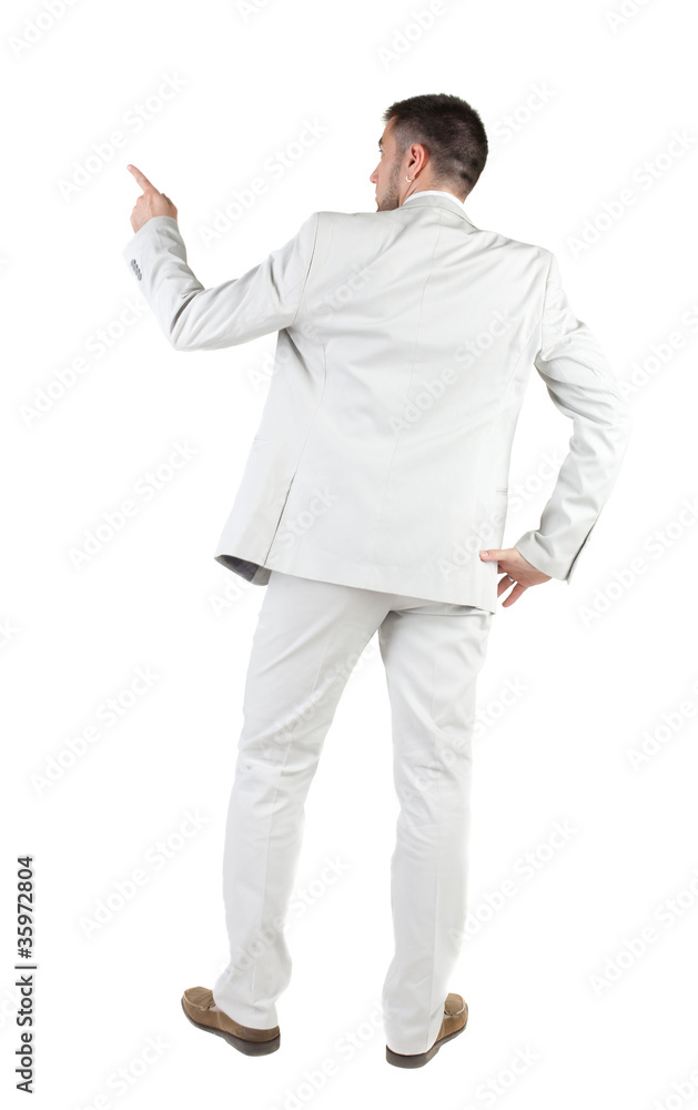 Businessman pointing at wall. rear view. Businessman pointing at wall. rear view.